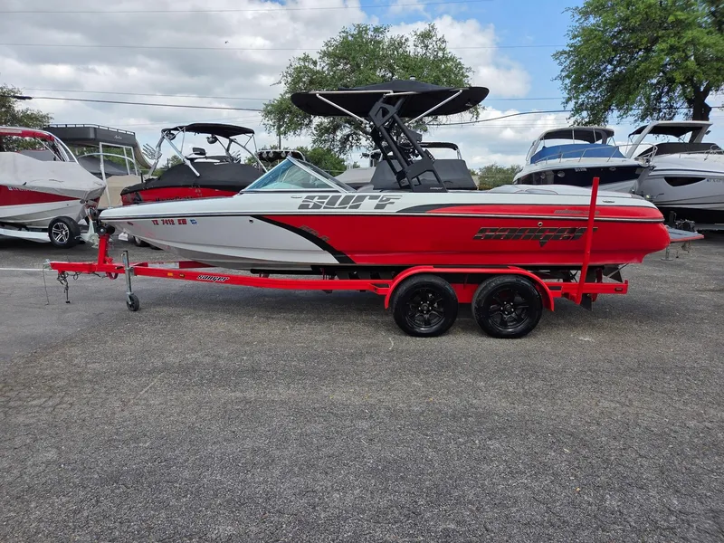 The Image of 2021 Sanger V215 S boat on red trailer, parked outdoors. - 0