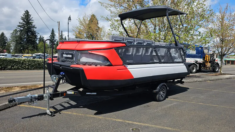 The Image of 2025 Sea-Doo Switch Cruise 21 pontoon boat on trailer, parked outdoors. - 0