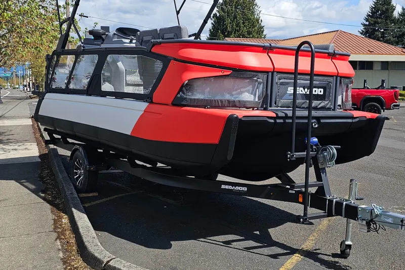 Slide: The Image of 2025 Sea-Doo Switch Cruise 21 on trailer, parked outdoors, showcasing modern design and vibrant colors. - 2