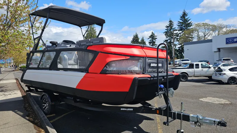 Slide: The Image of 2025 Sea-Doo Switch Cruise 21 pontoon boat on trailer, parked outdoors. - 3