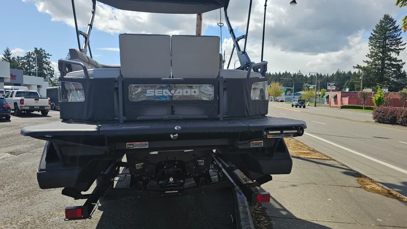 Slide: The Image of 2025 Sea-Doo Switch Cruise 21 on trailer, rear view, parked on street. - 7