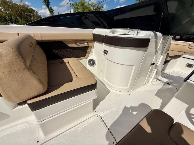 Slide: The Image of 2018 Sea Ray SDX 270 boat interior with beige seating and sleek design. - 12