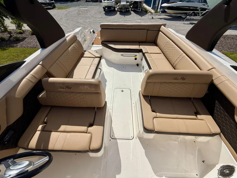 Slide: The Image of 2018 Sea Ray SDX 270 boat interior with tan leather seating and spacious layout. - 13
