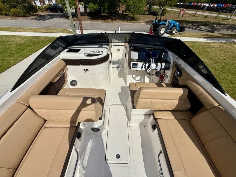 Slide: The Image of 2018 Sea Ray SDX 270 boat interior with tan seating and modern dashboard. - 15