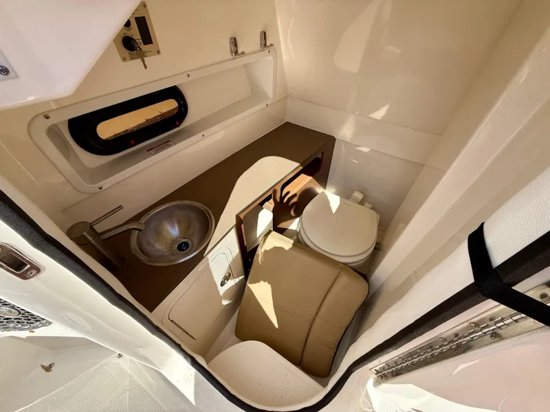 Slide: The Image of 2018 Sea Ray SDX 270 boat interior with sink, toilet, and window. - 16