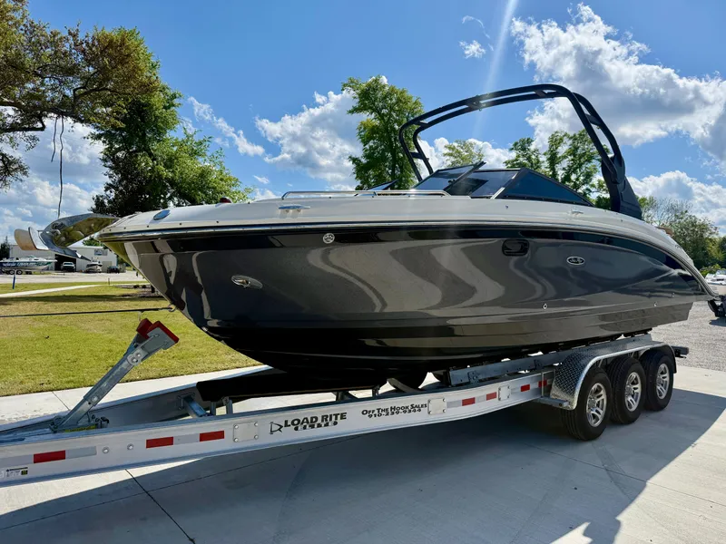 Slide: The Image of 2018 Sea Ray SDX 270 boat on trailer under clear blue sky. - 3