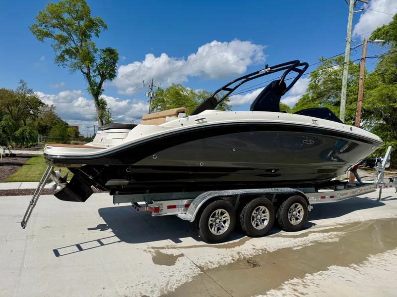 Slide: The Image of 2018 Sea Ray SDX 270 boat on trailer, parked outdoors under a clear blue sky. - 5