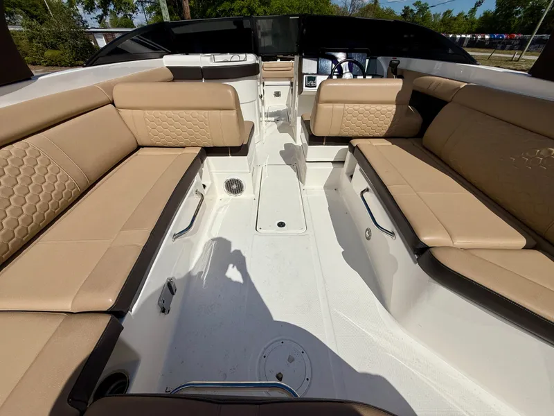 Slide: The Image of 2018 Sea Ray SDX 270 boat interior with beige seating and modern dashboard. - 9