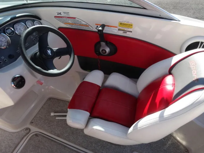 Slide: The Image of 2007 Sea Ray 185 Sport boat interior with red and white seating and steering wheel. - 12