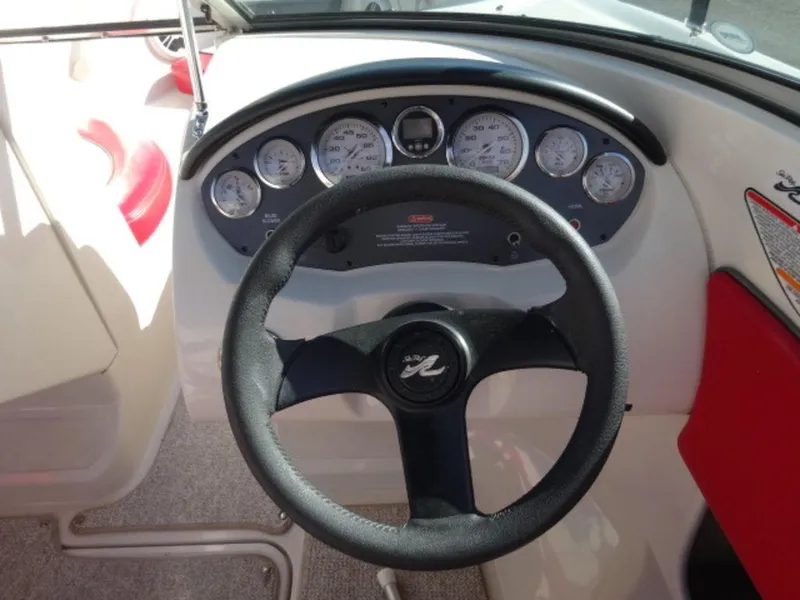 Slide: The Image of 2007 Sea Ray 185 Sport dashboard with steering wheel and instrument panel. - 13