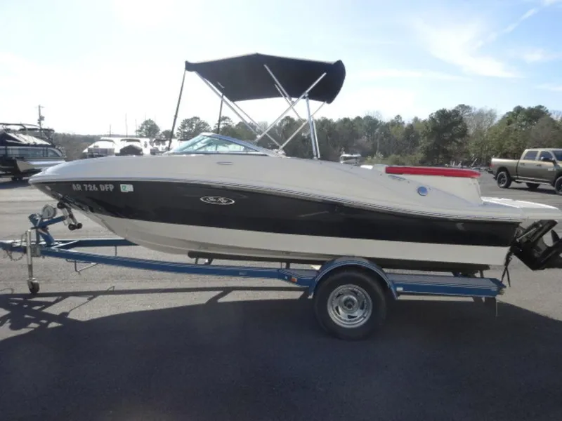 Slide: The Image of 2007 Sea Ray 185 Sport boat on trailer with canopy, parked outdoors. - 3