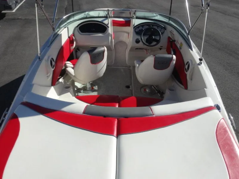 Slide: The Image of 2007 Sea Ray 185 Sport boat interior with red and white seating and steering console. - 5