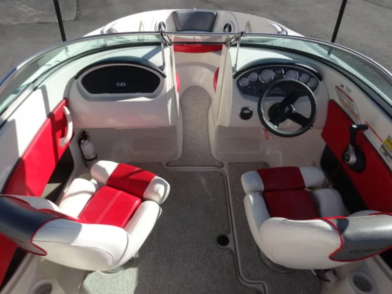 Slide: The Image of 2007 Sea Ray 185 Sport boat interior with red and white seating, steering wheel, and dashboard. - 9