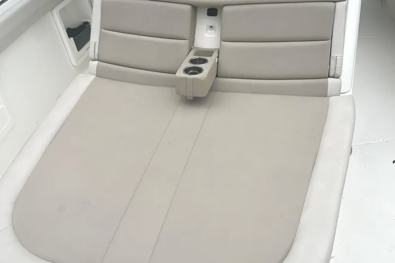 Slide: The Image of Boston Whaler 380 Outrage 2018 boat seating area with cup holders and cushioned backrest. - 13