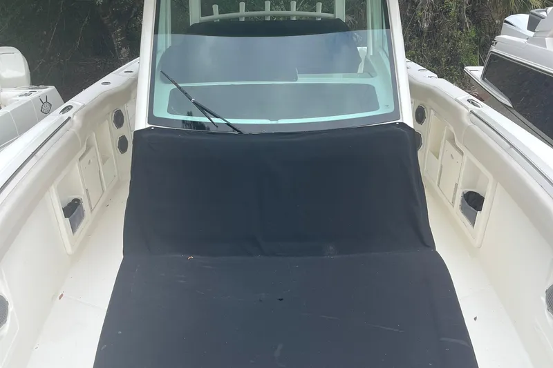 Slide: The Image of 2018 Boston Whaler 380 Outrage boat with covered seating area and windshield. - 14