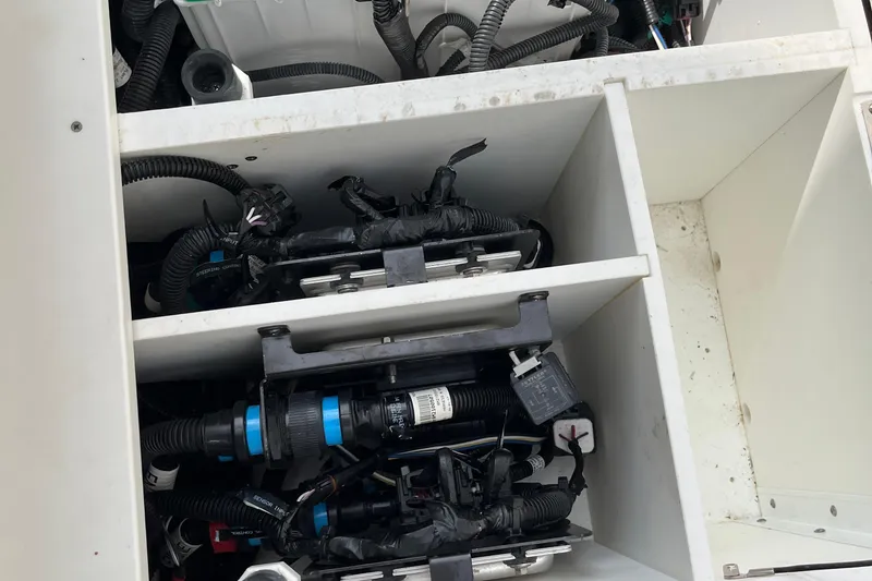 Slide: The Image of Storage compartment with wiring and equipment on a 2018 Boston Whaler 380 Outrage boat. - 19