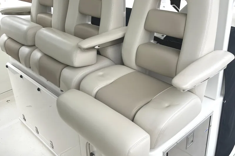 Slide: The Image of Luxurious seating on a 2018 Boston Whaler 380 Outrage boat, featuring plush beige upholstery. - 5