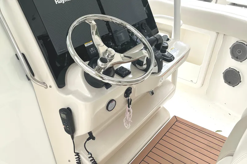Slide: The Image of 2018 Boston Whaler 380 Outrage helm with steering wheel and navigation controls. - 6