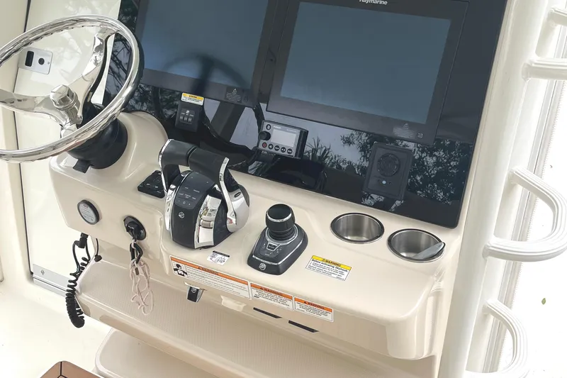 Slide: The Image of Control panel of 2018 Boston Whaler 380 Outrage with steering wheel and navigation screens. - 7
