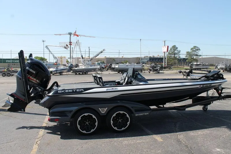 Slide: The Image of 2020 Skeeter FXR21 Apex boat in parking lot, side view, with trailer. - 4