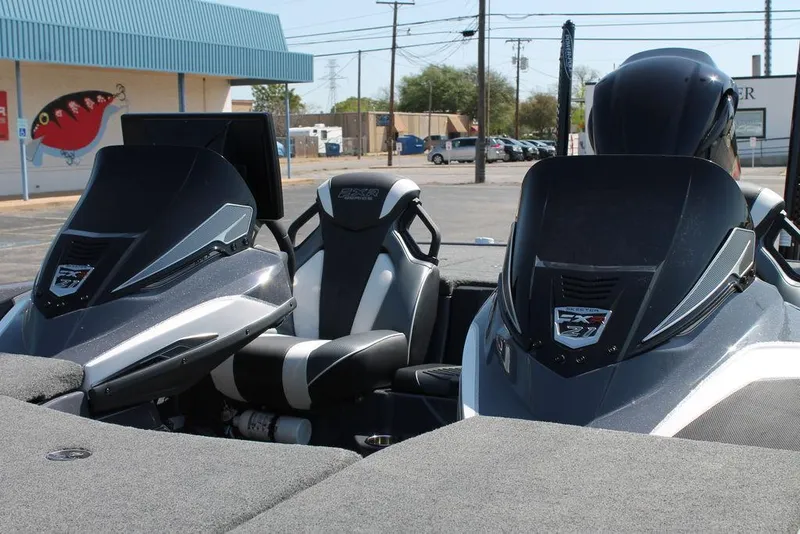 Slide: The Image of 2020 Skeeter FXR21 Apex boat interior with dual consoles and seating in a parking lot. - 8