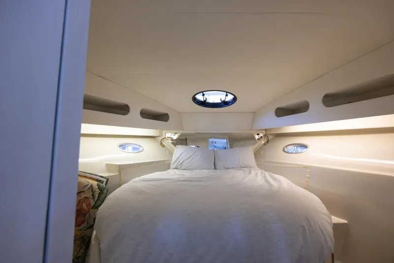 Slide: The Image of Cozy bedroom interior of 1990 Bluewater Yachts 55 Yacht with porthole windows. - 10