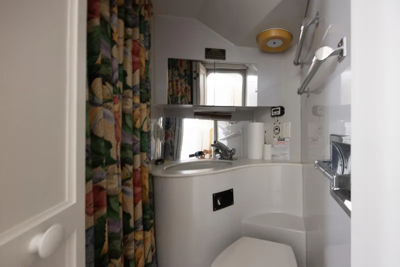 Slide: The Image of Bathroom interior of 1990 Bluewater Yachts 55 Yacht with colorful shower curtain. - 11