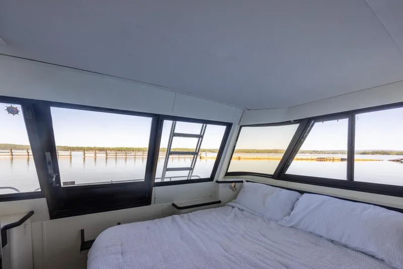 Slide: The Image of Interior cabin view of 1990 Bluewater Yachts 55 Yacht with scenic water views. - 13