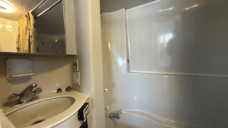 Slide: The Image of Bathroom interior of 1990 Bluewater Yachts 55 Yacht, featuring sink and shower. - 16