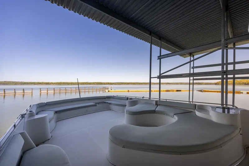 Slide: The Image of Spacious deck of 1990 Bluewater Yachts 55 Yacht with serene waterfront view. - 6