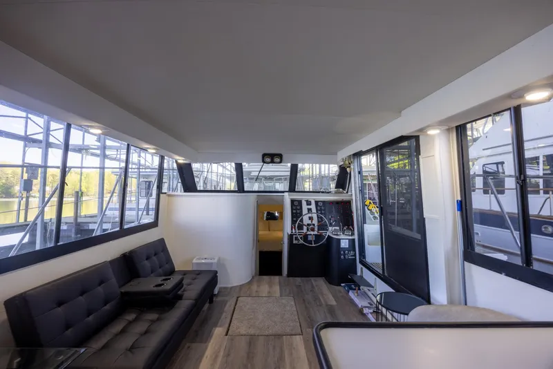 Slide: The Image of Interior of 1990 Bluewater Yachts 55 Yacht, featuring spacious seating and large windows. - 7