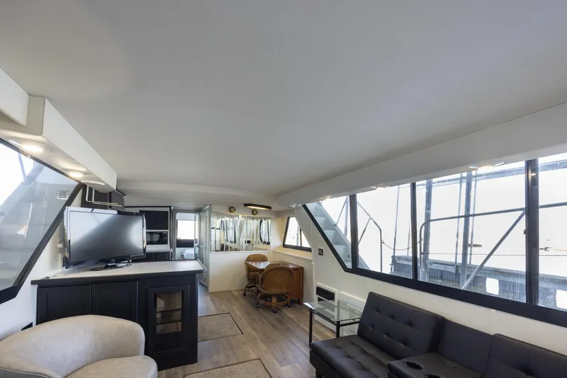 Slide: The Image of Interior of 1990 Bluewater Yachts 55 Yacht, featuring modern seating and large windows. - 8