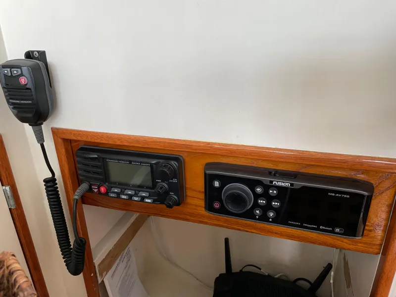 Slide: The Image of 1966 Huckins Sportsman boat radio and control panel with microphone and display. - 17