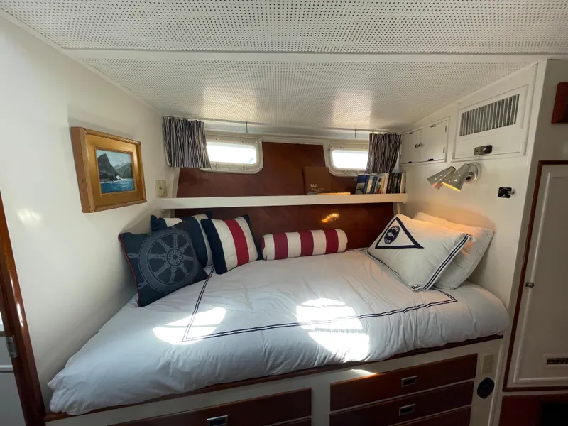 Slide: The Image of Cozy cabin interior of a 1966 Huckins Sportsman boat with nautical-themed decor. - 22