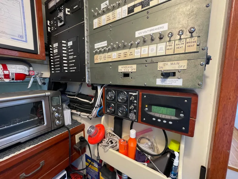 Slide: The Image of Electrical panel and equipment inside a 1966 Huckins Sportsman boat. - 40