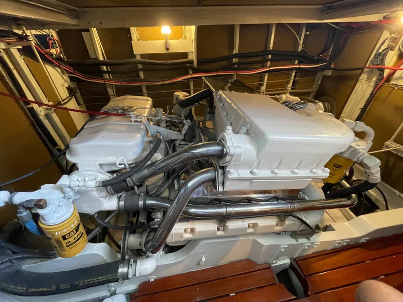 Slide: The Image of Engine room of a 1966 Huckins Sportsman boat, featuring well-maintained machinery and components. - 42
