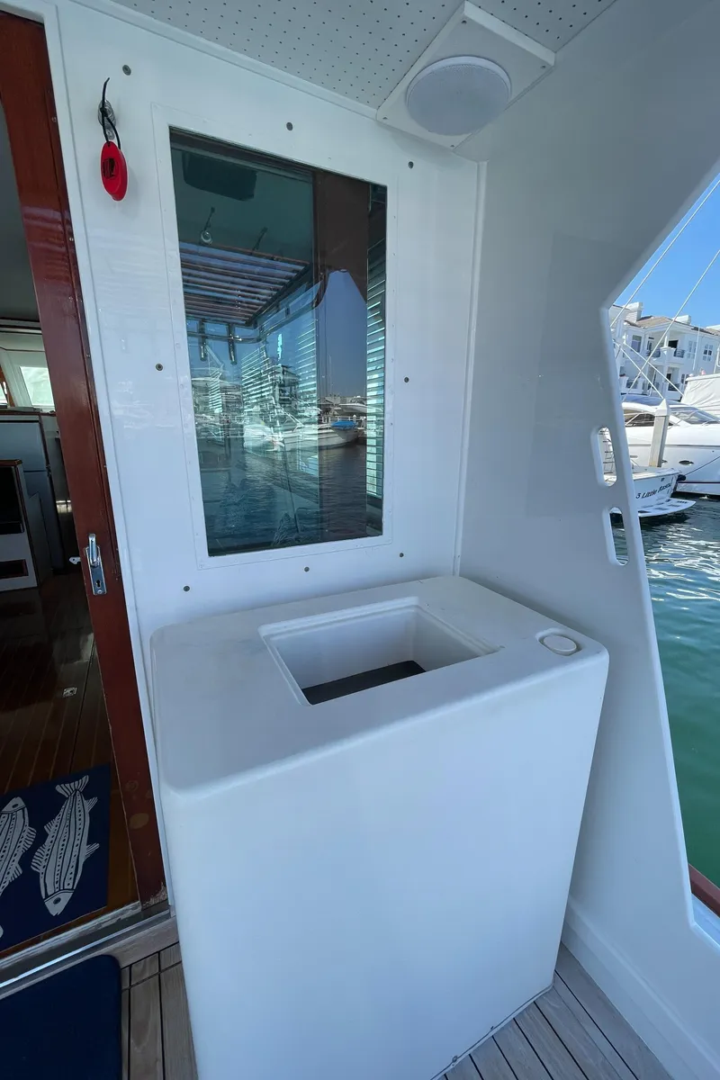 Slide: The Image of 1966 Huckins Sportsman boat interior with window and storage compartment. - 48