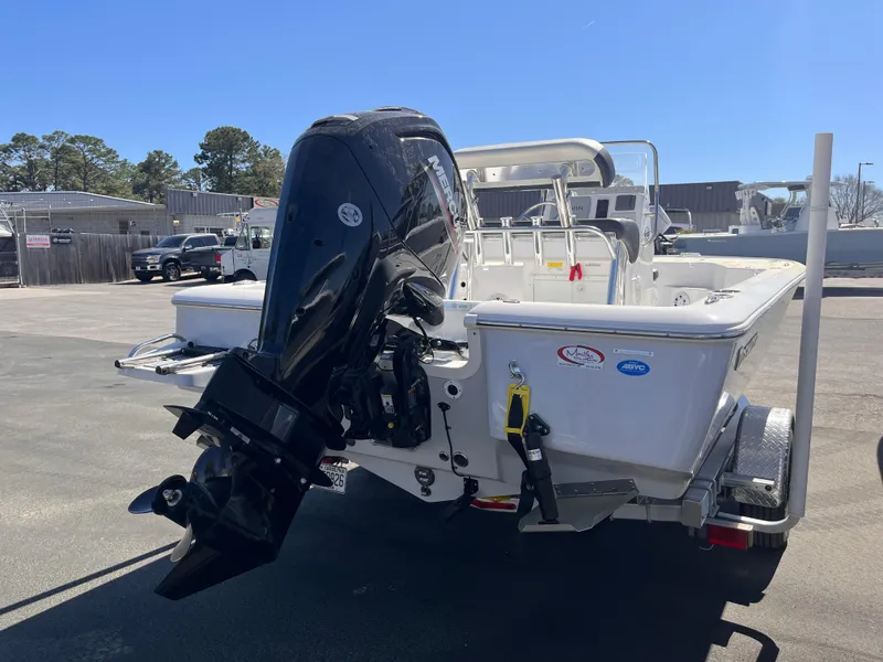Slide: The Image of 2024 Tidewater 1910 Bay Max boat with powerful outboard motor, parked outdoors. - 3
