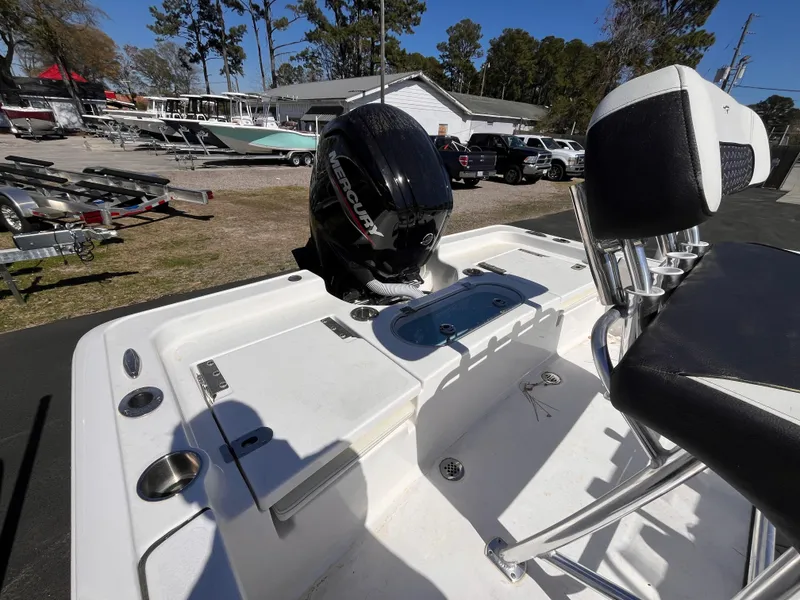 Slide: The Image of 2024 Tidewater 1910 Bay Max boat with Mercury engine, featuring seating and storage compartments. - 4