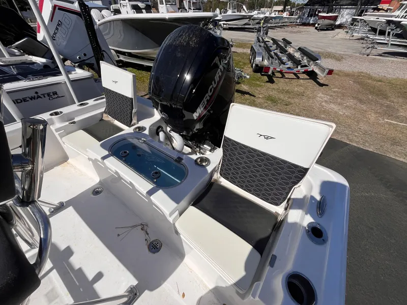 Slide: The Image of 2024 Tidewater 1910 Bay Max boat with Mercury engine, featuring seating and control panel. - 6