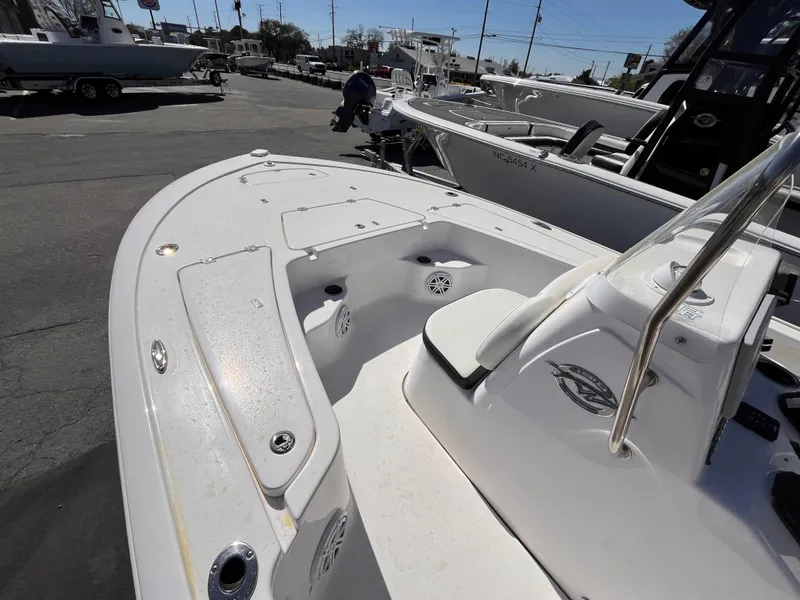 Slide: The Image of 2024 Tidewater 1910 Bay Max boat, white deck, spacious seating, parked outdoors. - 8