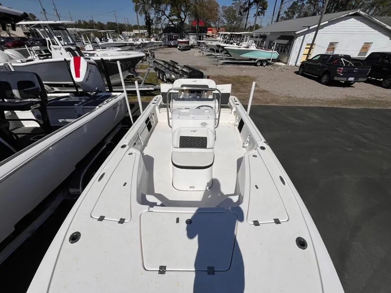 Slide: The Image of 2024 Tidewater 1910 Bay Max boat in a dealership lot, showcasing spacious deck layout. - 9
