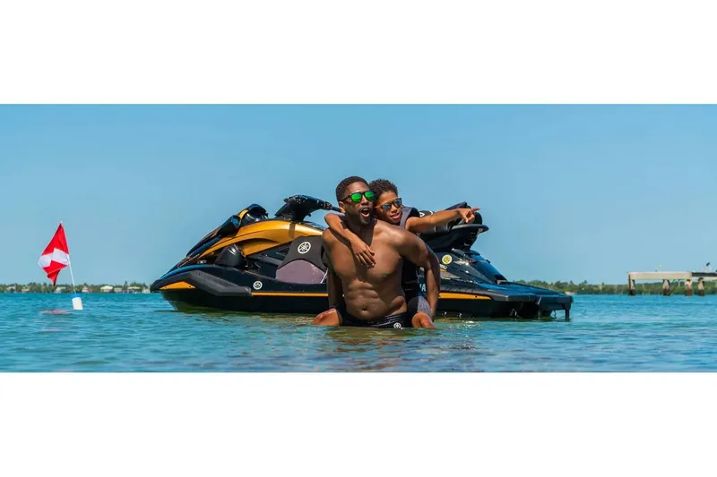 Slide: The Image of Two people enjoying water near a 2024 Yamaha FX Limited SVHO jet ski. - 10