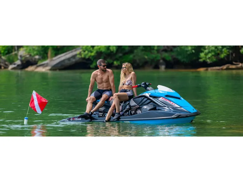Slide: The Image of 2024 Yamaha Boats GP HO jet ski with two people on a lake. - 8