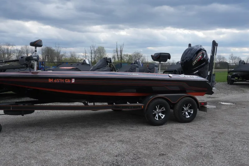 Slide: The Image of 2018 Skeeter ZX200 bass boat on trailer under cloudy sky. - 20