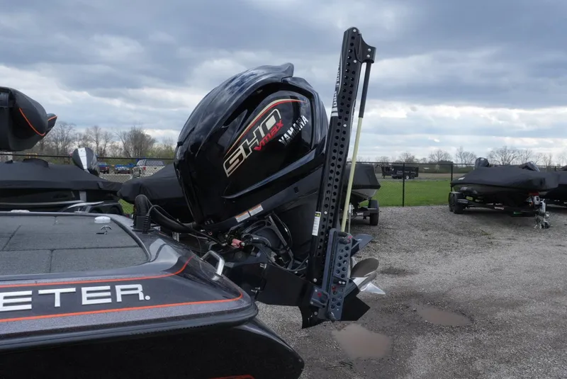 Slide: The Image of 2018 Skeeter ZX200 boat with powerful outboard motor, parked on gravel under cloudy skies. - 8