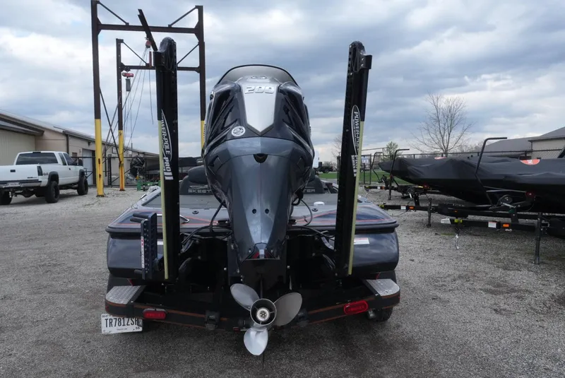 Slide: The Image of 2018 Skeeter ZX200 boat, rear view, parked outdoors under cloudy sky. - 9