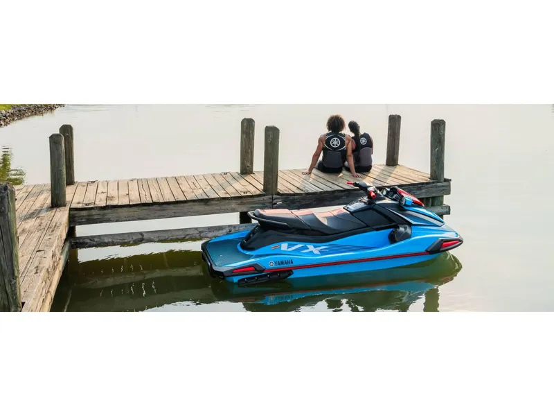 Slide: The Image of 2024 Yamaha VX Deluxe jet ski docked by a wooden pier with two people sitting. - 10
