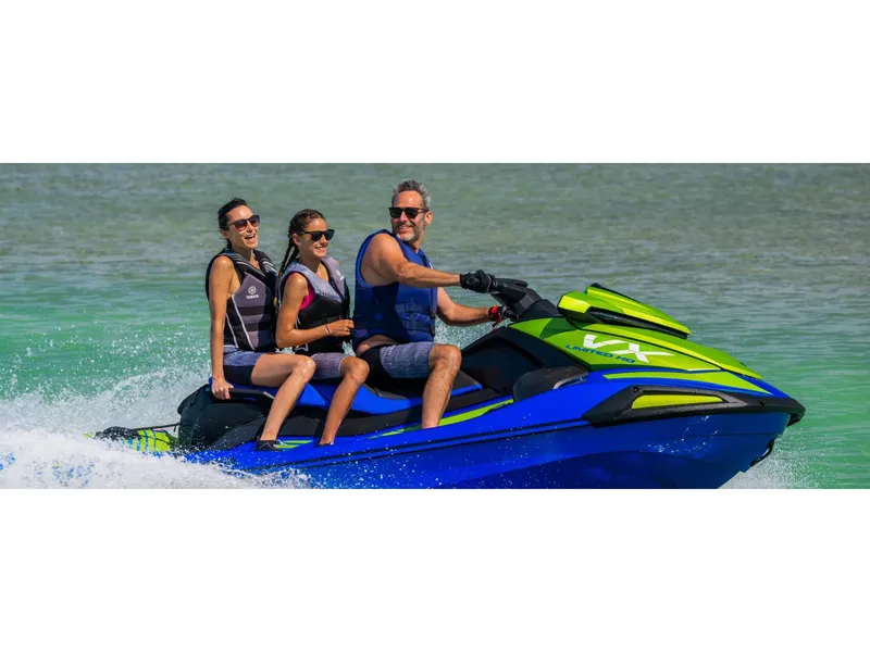 Slide: The Image of 2024 Yamaha VX Limited HO jet ski with three riders enjoying a sunny day on the water. - 10