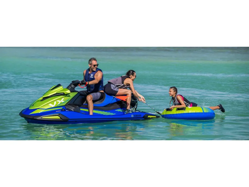 Slide: The Image of 2024 Yamaha VX Limited HO jet ski towing a person on an inflatable tube in clear water. - 11